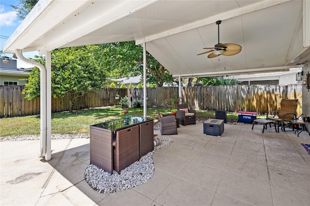 2220 Derbyshire Rd, Maitland, FL 32751 - fenced backyard with a patio, an outdoor hangout area, and a ceiling fan