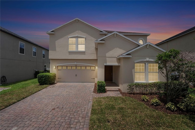 7409 Fairgrove Ave, Windermere, FL 34786 - traditional-style house featuring stucco siding, decorative driveway, a garage, and a front yard