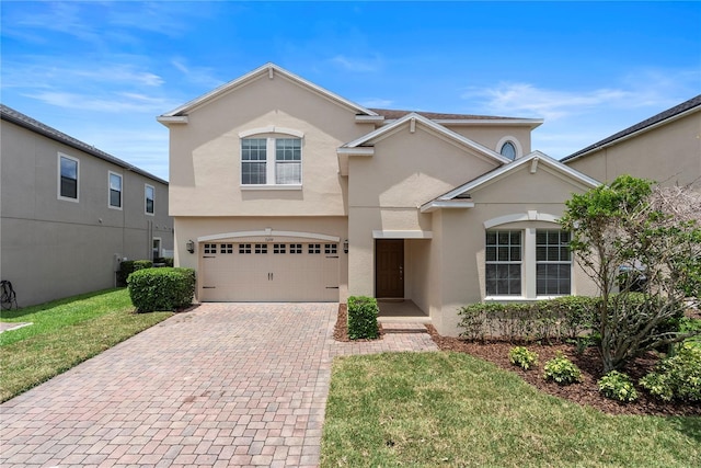 7409 Fairgrove Ave, Windermere, FL 34786 - view of front facade featuring stucco siding, decorative driveway, an attached garage, and a front yard