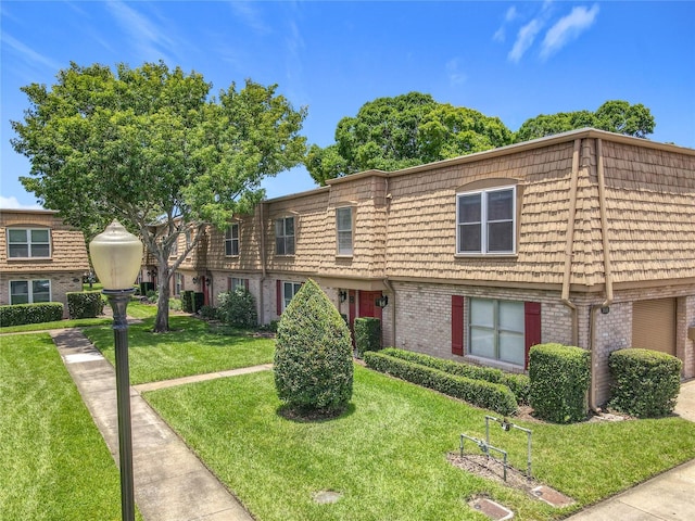 200 St Andrews Blvd Unit 911, Winter Park, FL 32792 - townhome / multi-family property featuring mansard roof, brick siding, and a front lawn