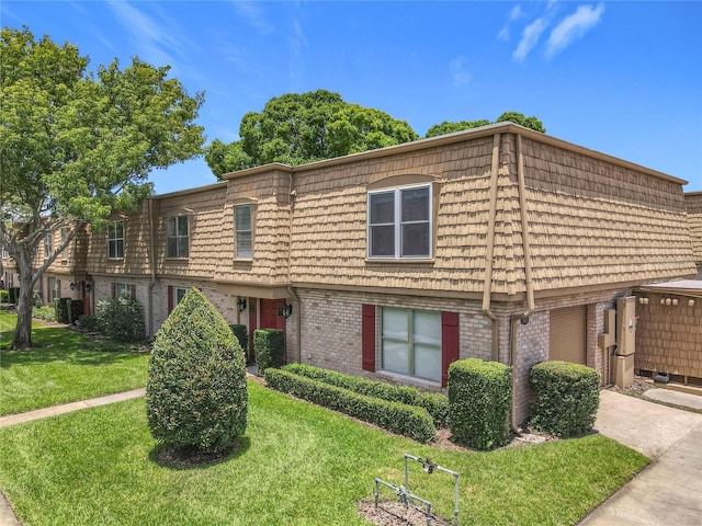 200 St Andrews Blvd Unit 911, Winter Park, FL 32792 - view of front of house featuring mansard roof, brick siding, and a front yard