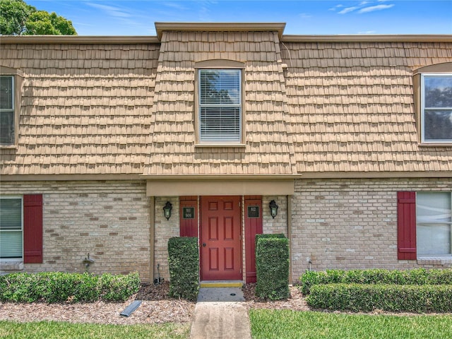 200 St Andrews Blvd Unit 911, Winter Park, FL 32792 - view of front of home with mansard roof and brick siding