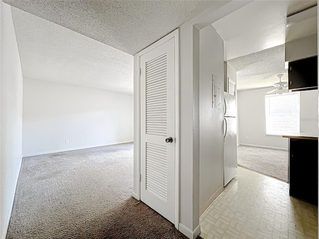 200 St Andrews Blvd Unit 911, Winter Park, FL 32792 - corridor featuring a textured ceiling and light carpet