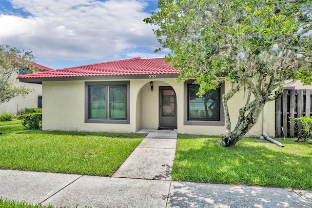 557 Hunter Cir, Kissimmee, FL 34758 - view of front of property with stucco siding, a tile roof, and covered porch