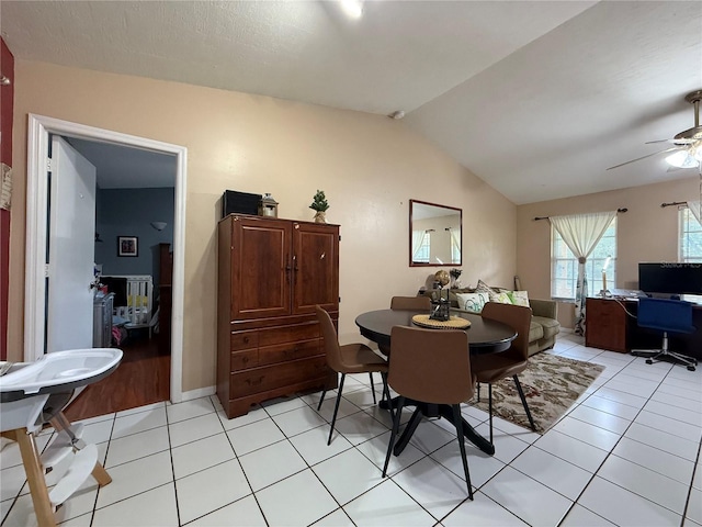 831 Fletcher Rd SE, Palm Bay, FL 32909 - dining room with lofted ceiling, ceiling fan, and light tile patterned floors