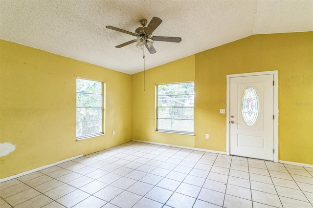 1212 N Hudson St, Orlando, FL 32808 - foyer entrance featuring lofted ceiling, plenty of natural light, ceiling fan, a textured ceiling, and light tile patterned flooring