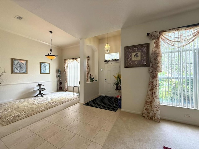 3539 Maple Ridge Loop, Kissimmee, FL 34741 - entryway featuring plenty of natural light, light tile patterned floors, and ornamental molding