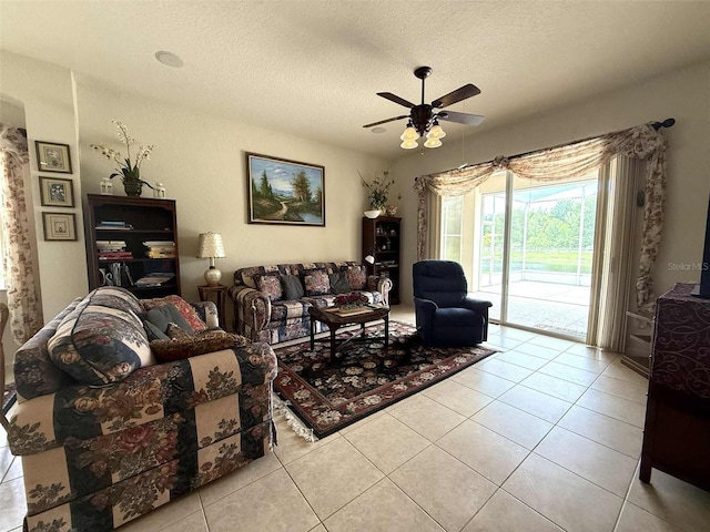 3539 Maple Ridge Loop, Kissimmee, FL 34741 - living area with light tile patterned floors, a ceiling fan, and a textured ceiling