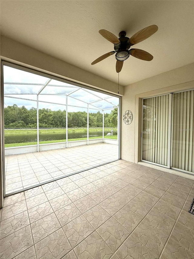 3539 Maple Ridge Loop, Kissimmee, FL 34741 - unfurnished sunroom with a ceiling fan and view of scattered trees