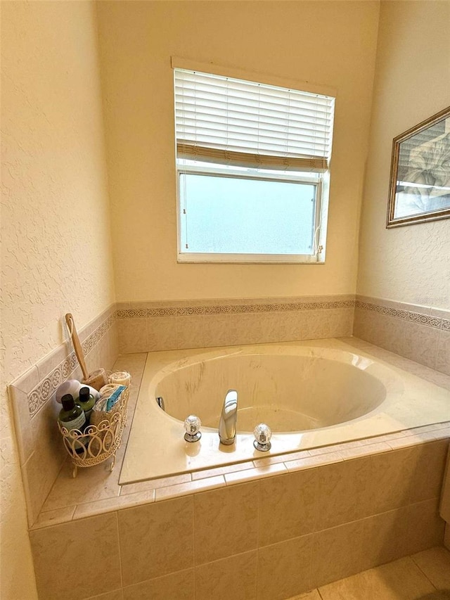 3539 Maple Ridge Loop, Kissimmee, FL 34741 - full bathroom featuring a garden tub and a textured wall