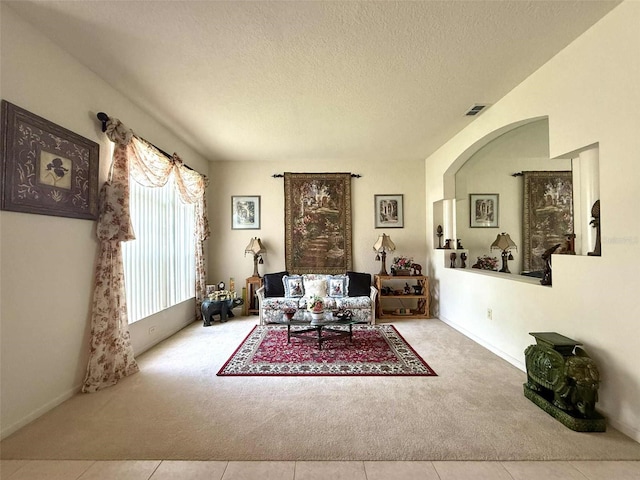 3539 Maple Ridge Loop, Kissimmee, FL 34741 - living room featuring carpet flooring, a textured ceiling, and tile patterned floors