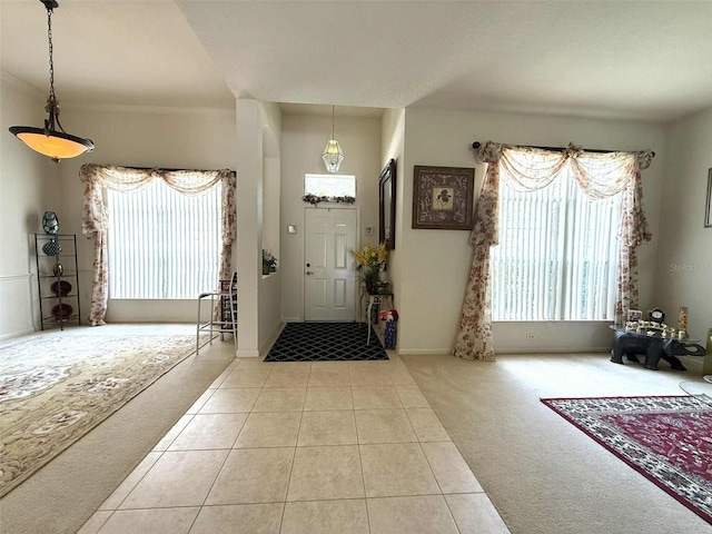 3539 Maple Ridge Loop, Kissimmee, FL 34741 - entryway with carpet, healthy amount of natural light, and tile patterned flooring
