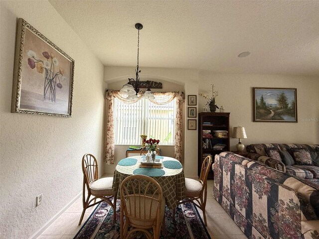 3539 Maple Ridge Loop, Kissimmee, FL 34741 - dining room featuring a chandelier, light tile patterned flooring, a textured wall, and a textured ceiling