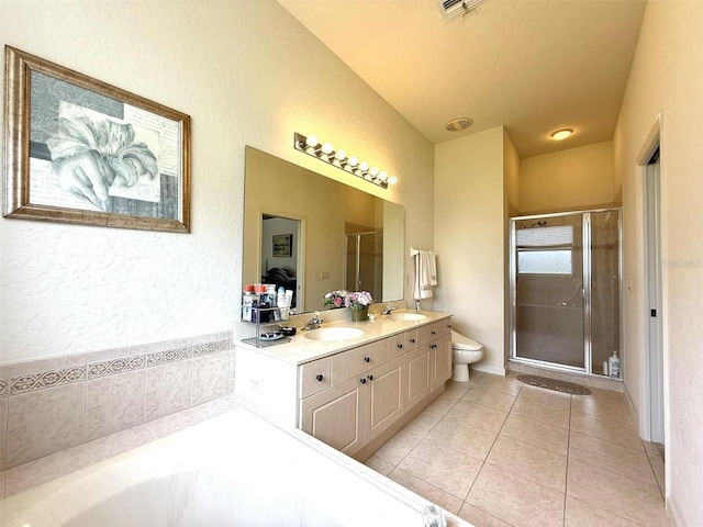 3539 Maple Ridge Loop, Kissimmee, FL 34741 - bathroom with tile patterned flooring, a stall shower, double vanity, a textured wall, and lofted ceiling