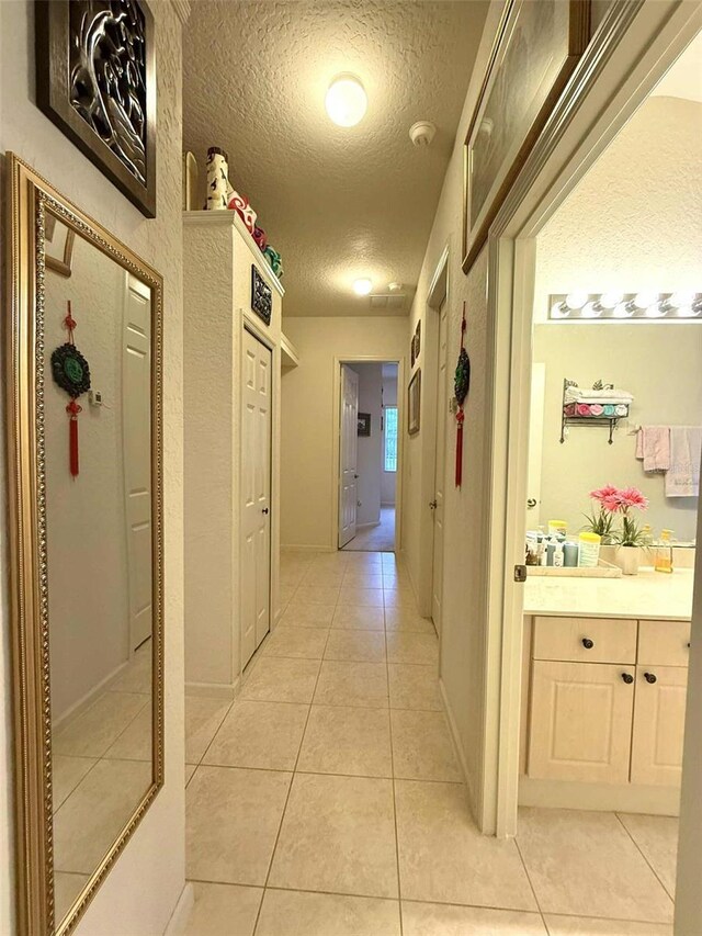 3539 Maple Ridge Loop, Kissimmee, FL 34741 - hall with a textured ceiling and light tile patterned floors