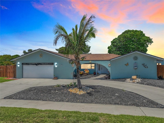 1475 Mars St, Merritt Island, FL 32953 - view of front of home featuring concrete driveway, an attached garage, and stucco siding