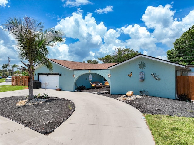 1475 Mars St, Merritt Island, FL 32953 - view of front of property with stucco siding, curved driveway, and an attached garage