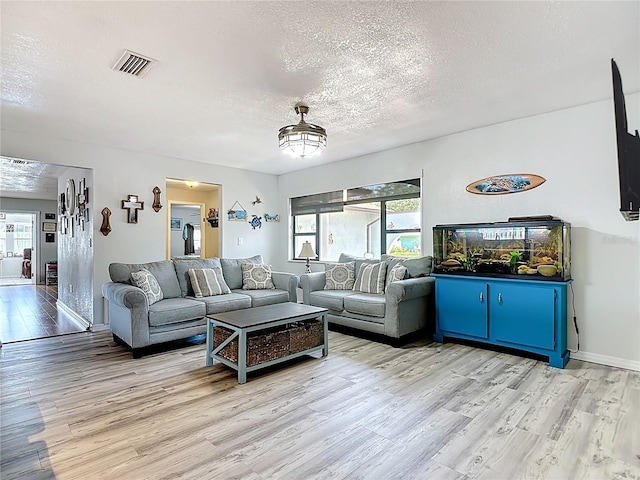 1475 Mars St, Merritt Island, FL 32953 - living room featuring light wood finished floors and a textured ceiling