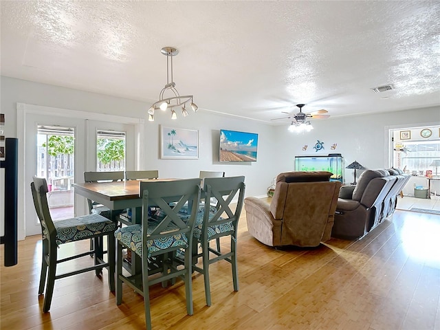 1475 Mars St, Merritt Island, FL 32953 - dining room with a textured ceiling, plenty of natural light, light wood-style floors, and a ceiling fan