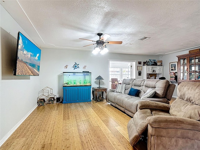 1475 Mars St, Merritt Island, FL 32953 - living room featuring wood finished floors, a ceiling fan, and a textured ceiling