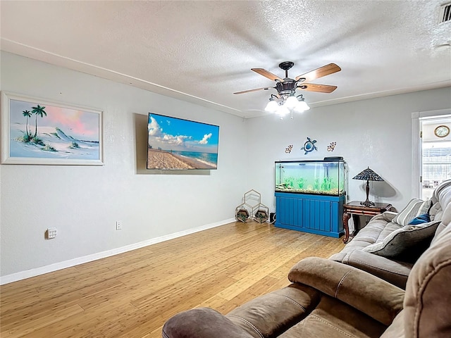 1475 Mars St, Merritt Island, FL 32953 - living area with a textured ceiling, wood finished floors, and ceiling fan