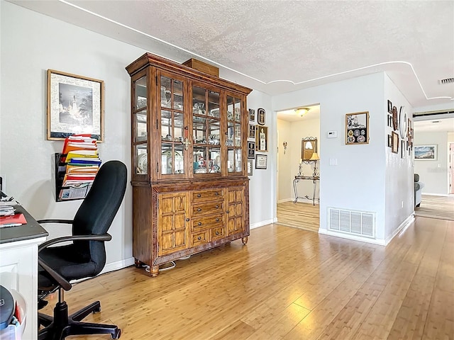 1475 Mars St, Merritt Island, FL 32953 - home office featuring light wood-style floors and a textured ceiling