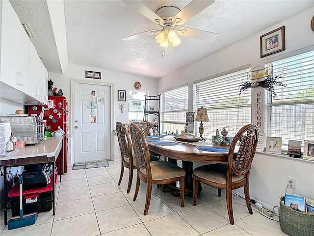 1475 Mars St, Merritt Island, FL 32953 - dining room with a textured ceiling, light tile patterned floors, and a ceiling fan