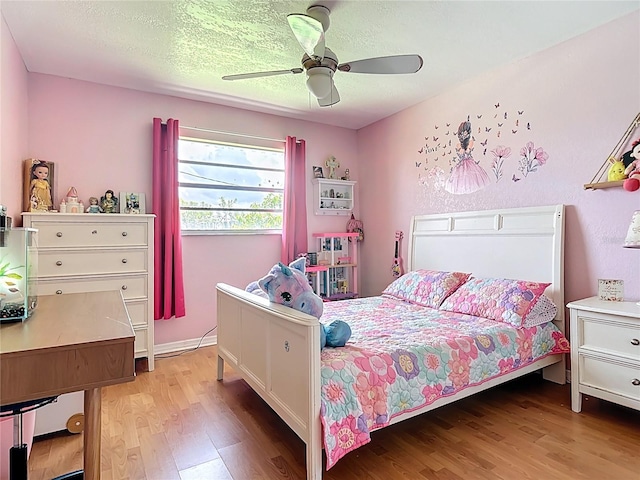 1475 Mars St, Merritt Island, FL 32953 - bedroom with light wood-style floors, ceiling fan, and a textured ceiling