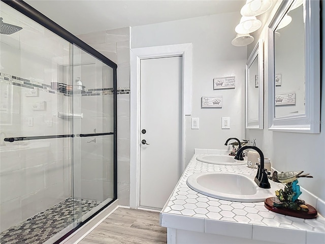 1475 Mars St, Merritt Island, FL 32953 - bathroom featuring a stall shower, wood finished floors, and double vanity