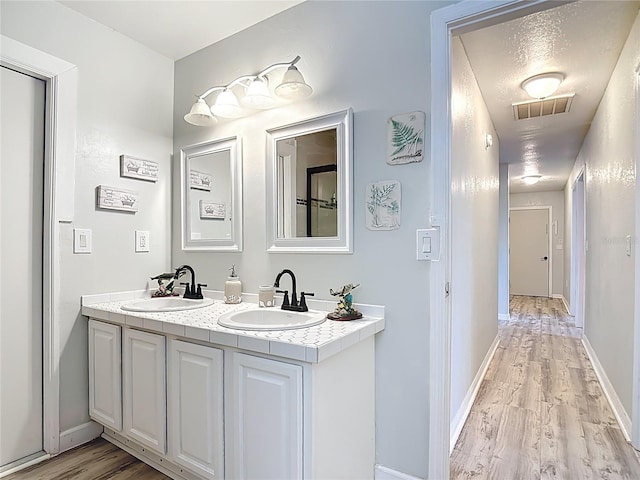 1475 Mars St, Merritt Island, FL 32953 - full bathroom featuring wood finished floors and double vanity