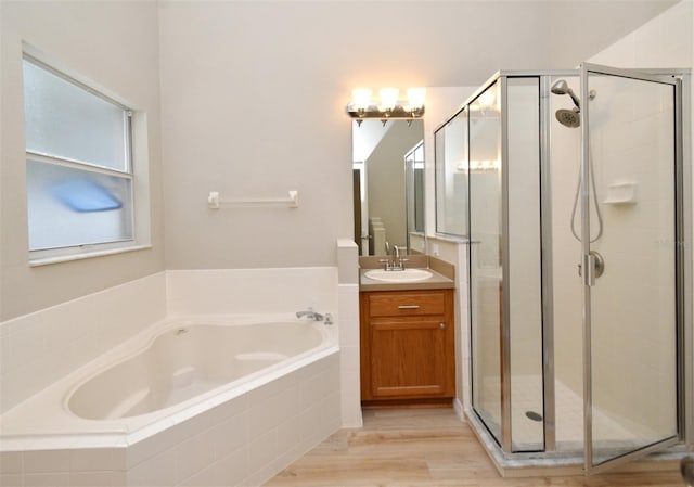 2131 Kaylas Ct, Orlando, FL 32817 - bathroom featuring a bath, vanity, a shower stall, and wood finished floors