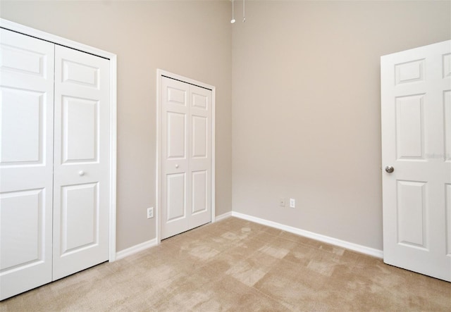 2131 Kaylas Ct, Orlando, FL 32817 - unfurnished bedroom with light colored carpet and multiple closets