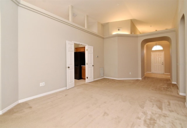 2131 Kaylas Ct, Orlando, FL 32817 - carpeted empty room with arched walkways and a towering ceiling