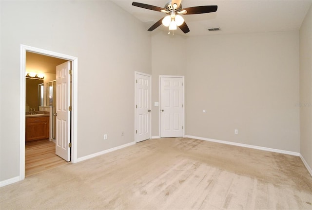 2131 Kaylas Ct, Orlando, FL 32817 - unfurnished bedroom with light colored carpet, high vaulted ceiling, ensuite bathroom, and ceiling fan