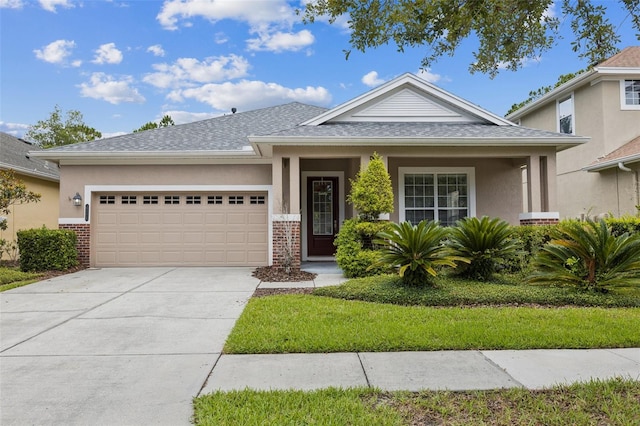 20074 Heritage Point Dr, Tampa, FL 33647 - view of front of house with a garage, brick siding, driveway, roof with shingles, and stucco siding