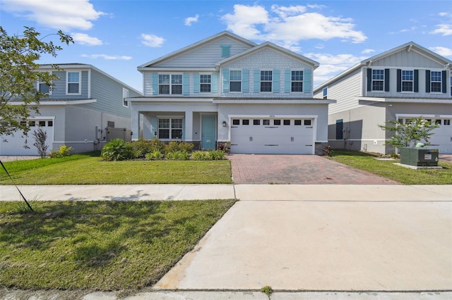 2056 Airedale Way, Lake Alfred, FL 33850 - craftsman inspired home featuring decorative driveway, a garage, and a front yard