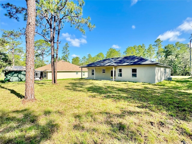 2176 W Galaxy Ln, Citrus Springs, FL 34434 - back of property featuring a yard