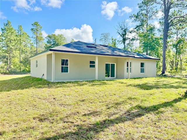 2176 W Galaxy Ln, Citrus Springs, FL 34434 - back of property with a lawn and stucco siding