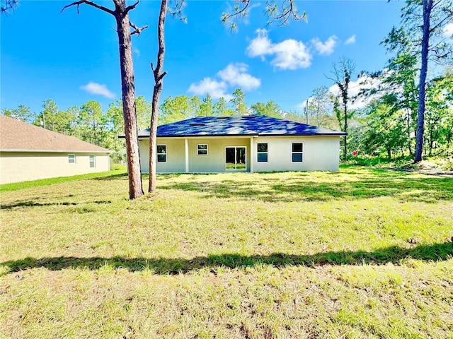 2176 W Galaxy Ln, Citrus Springs, FL 34434 - rear view of property featuring a lawn and stucco siding