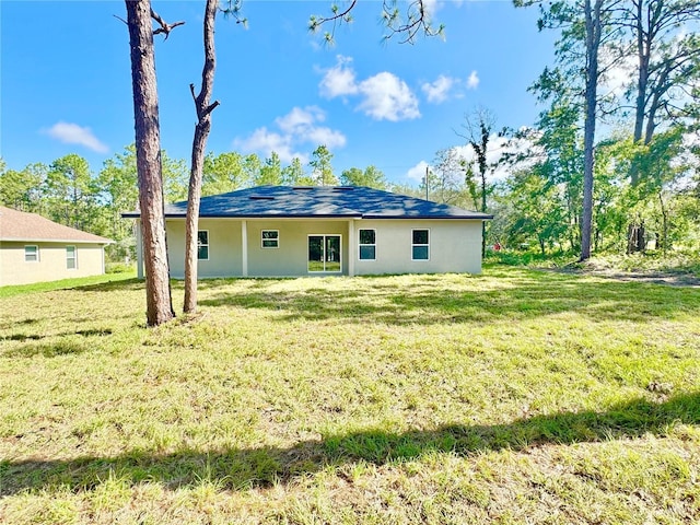 2176 W Galaxy Ln, Citrus Springs, FL 34434 - back of house with a yard and stucco siding