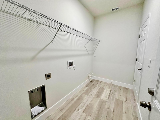 2176 W Galaxy Ln, Citrus Springs, FL 34434 - laundry room featuring hookup for an electric dryer, light wood-style flooring, and washer hookup