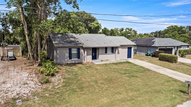 1066 Swanson Dr, Deltona, FL 32738 - ranch-style home with concrete driveway, stucco siding, and a shingled roof