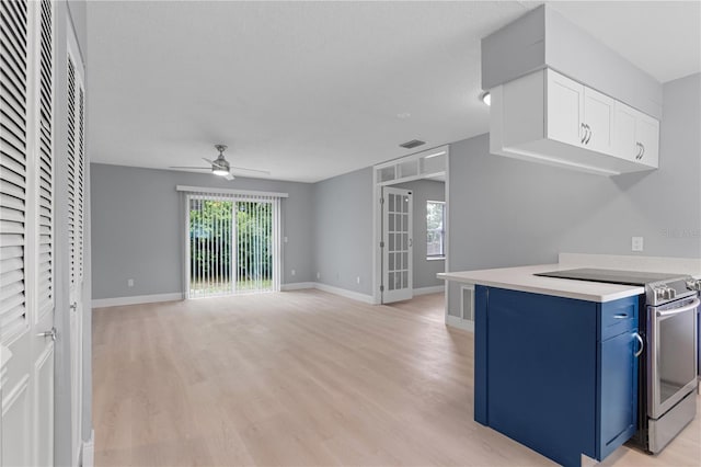 1066 Swanson Dr, Deltona, FL 32738 - kitchen with electric range, blue cabinetry, light wood-style floors, and ceiling fan