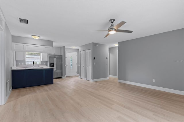 1066 Swanson Dr, Deltona, FL 32738 - unfurnished living room with ceiling fan and light wood-style flooring