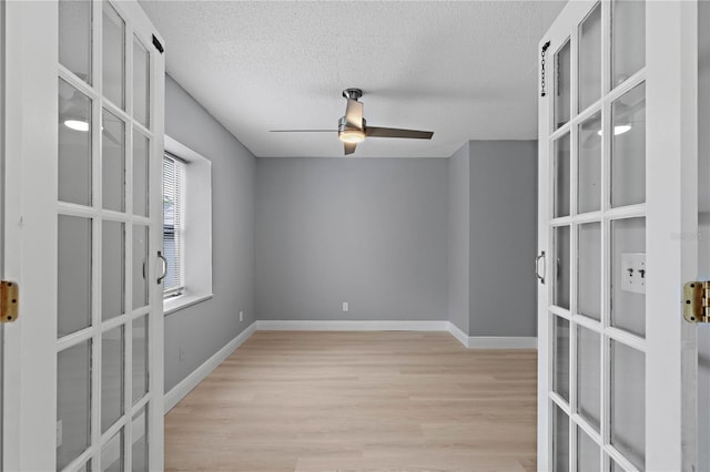 1066 Swanson Dr, Deltona, FL 32738 - empty room with french doors, light wood finished floors, ceiling fan, and a textured ceiling