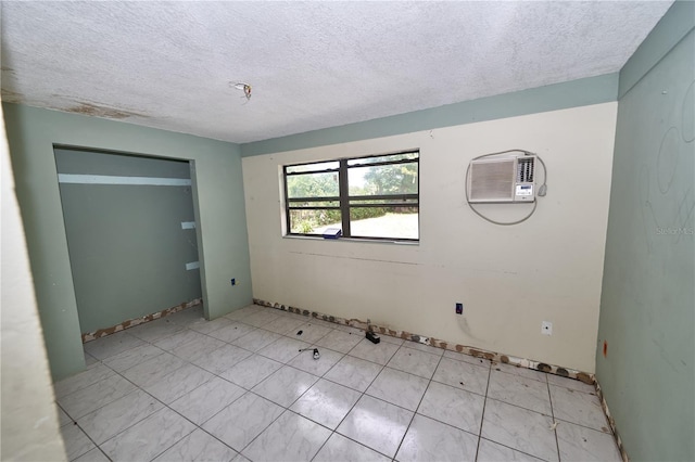 535 Romano Ave, Orlando, FL 32807 - unfurnished bedroom with an AC wall unit and a textured ceiling
