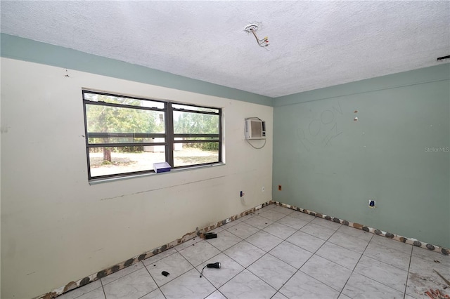 535 Romano Ave, Orlando, FL 32807 - spare room featuring a textured ceiling and a wall unit AC