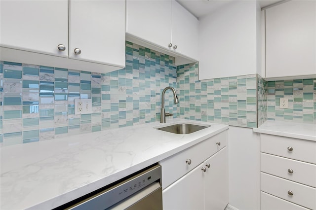 2700 Ocean Shore Blvd Unit 515, Ormond Beach, FL 32176 - kitchen featuring decorative backsplash, dishwasher, white cabinetry, and light stone countertops