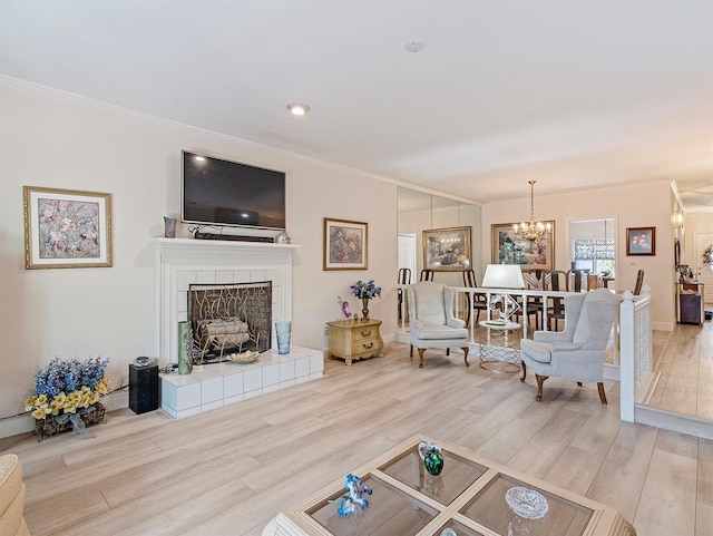 235 S Shadowbay Blvd, Longwood, FL 32779 - living room with crown molding, wood finished floors, a chandelier, and a tile fireplace