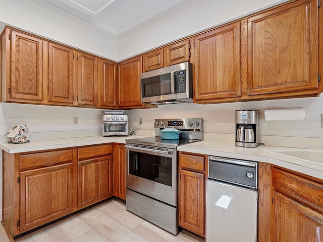 235 S Shadowbay Blvd, Longwood, FL 32779 - kitchen featuring appliances with stainless steel finishes, brown cabinets, light countertops, and crown molding